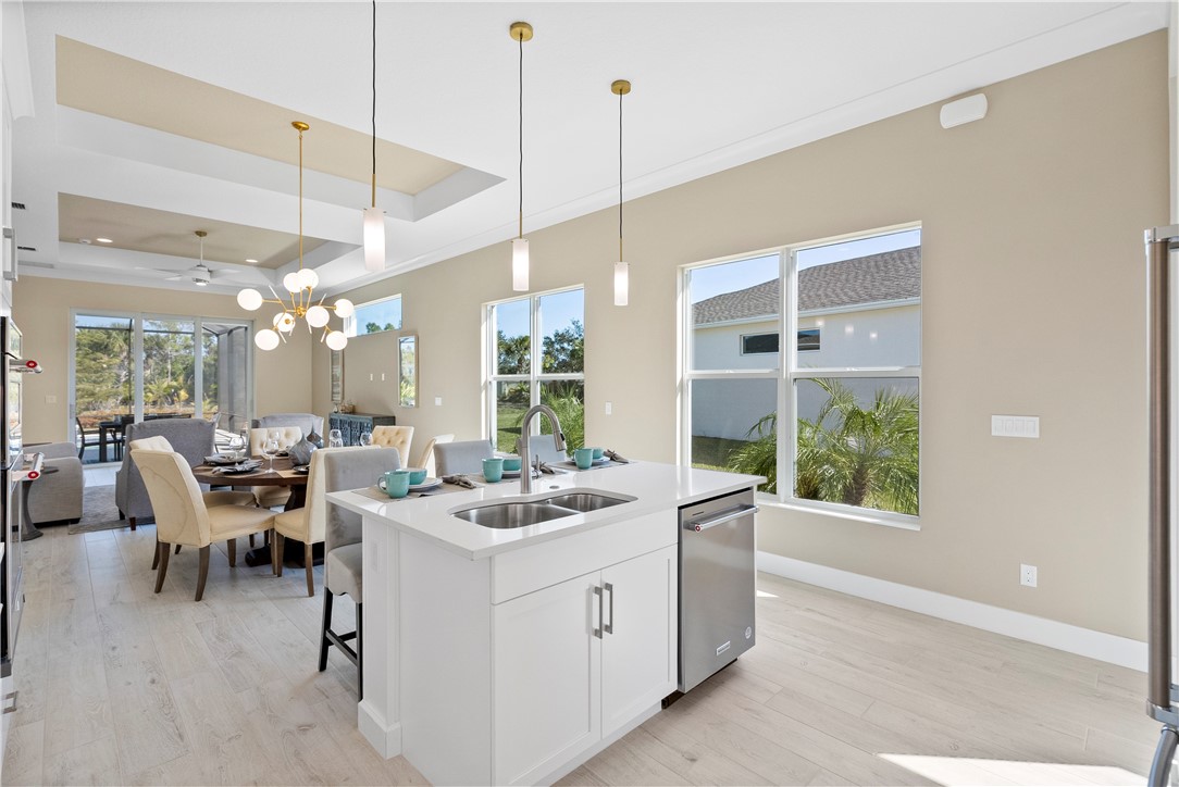 2148 Falls Manor Vero Beach, FL 32967 - Photo 12 of 25 a kitchen with a sink and chairs
