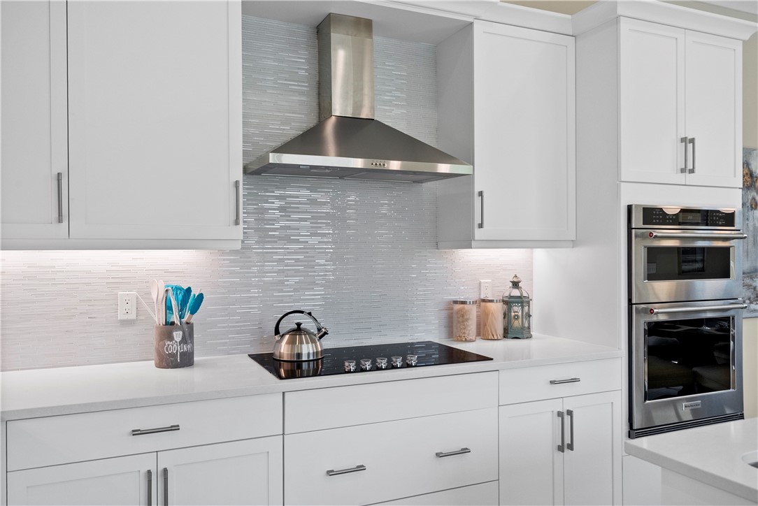 2148 Falls Manor Vero Beach, FL 32967 - Photo 13 of 25 a kitchen with stainless steel appliances a sink a stove and cabinets