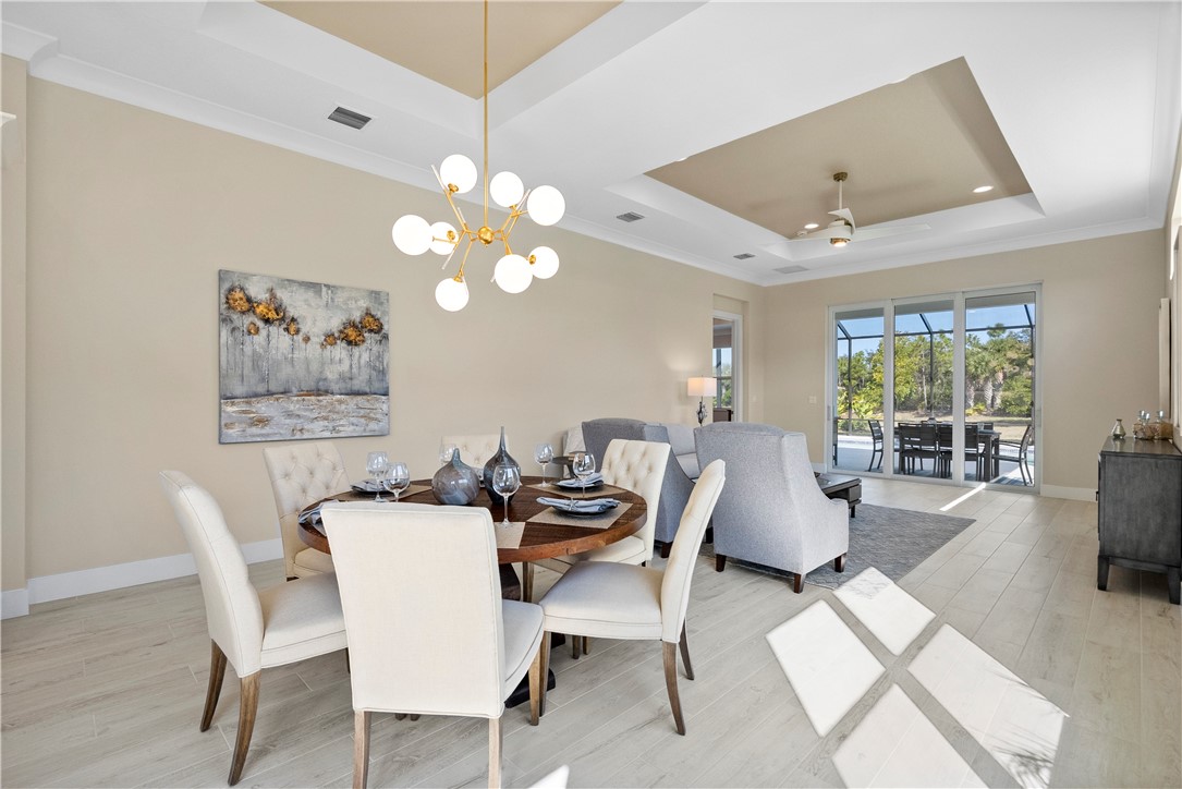 2148 Falls Manor Vero Beach, FL 32967 - Photo 14 of 25 a dining room with furniture a livingroom view and wooden floor
