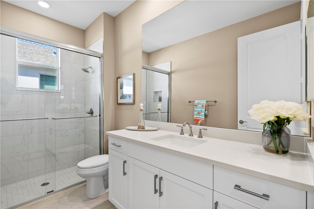 2148 Falls Manor Vero Beach, FL 32967 - Photo 18 of 25 a bathroom with a sink a toilet and shower