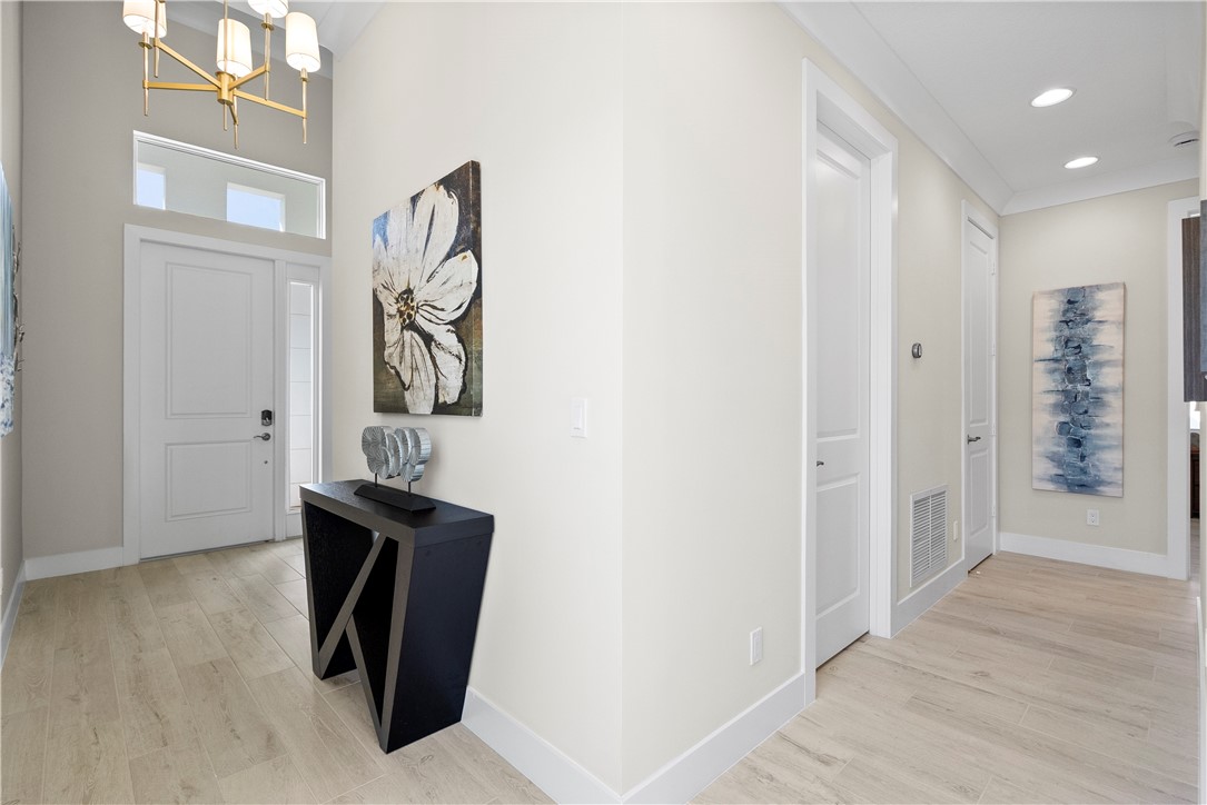 2148 Falls Manor Vero Beach, FL 32967 - Photo 7 of 25 a view of a hallway with wooden floor and entryway