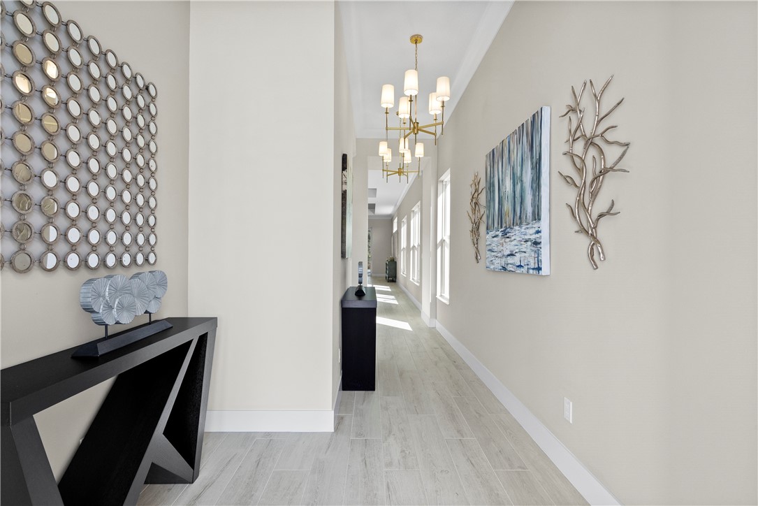 2148 Falls Manor Vero Beach, FL 32967 - Photo 8 of 25 a view of a hallway with wooden floor and staircase
