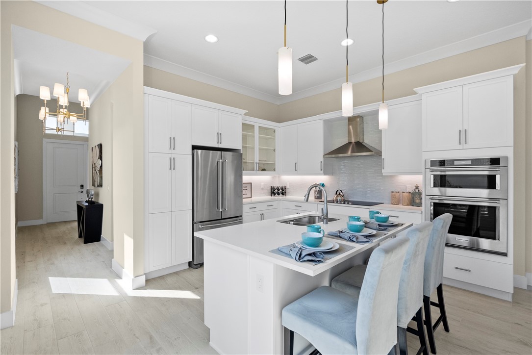 2148 Falls Manor Vero Beach, FL 32967 - Photo 10 of 25 a kitchen with refrigerator a stove a sink and a refrigerator