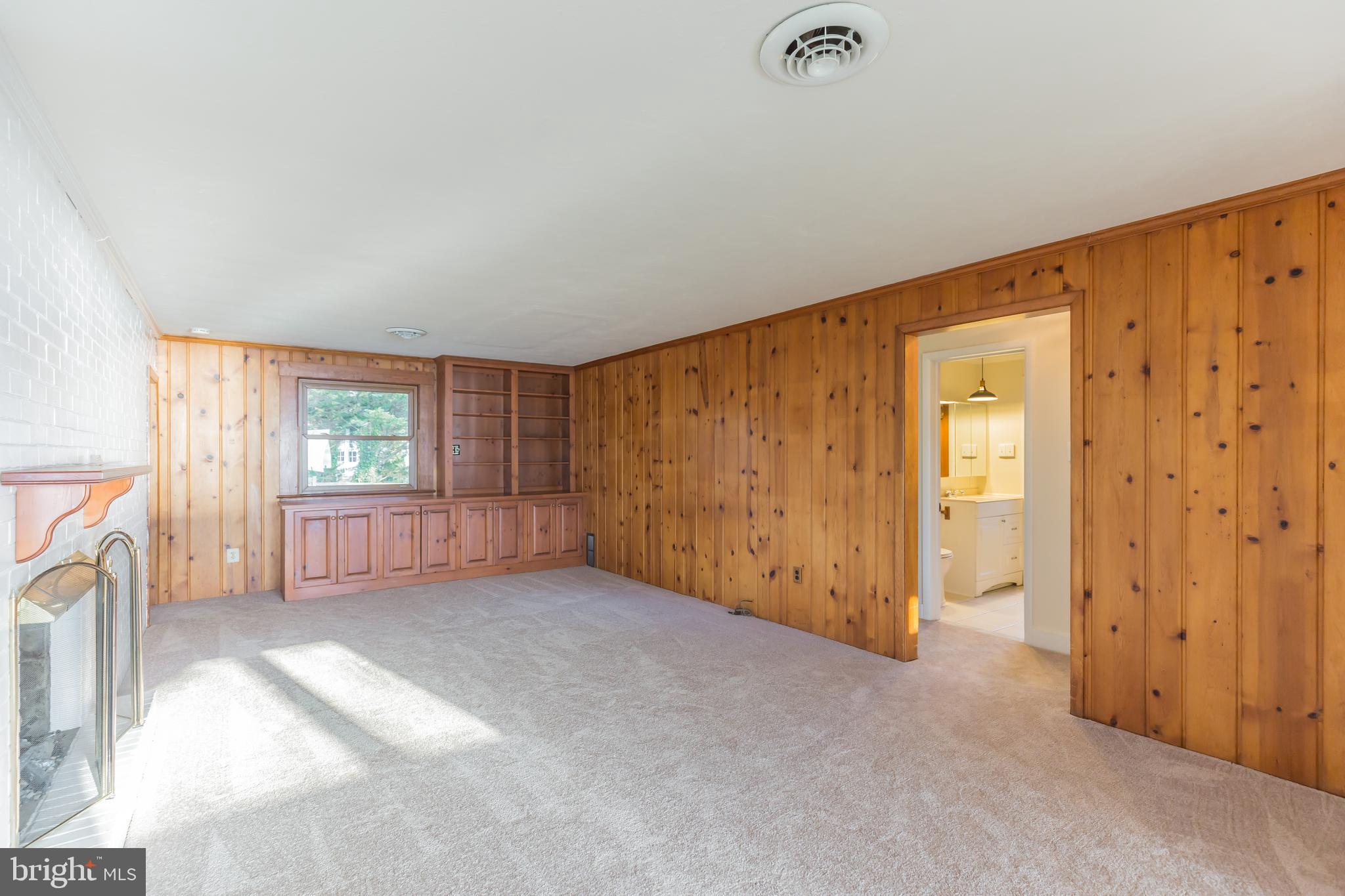 4144 School Road Broomes Island, MD 20615 - Photo 17 of 45 Living Room with knotty pine walls & built-ins