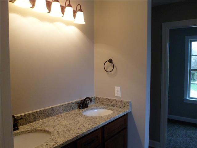 532 Halltown Road Portland, TN 37148 - Photo 12 of 15 a bathroom with a granite countertop sink and vanity