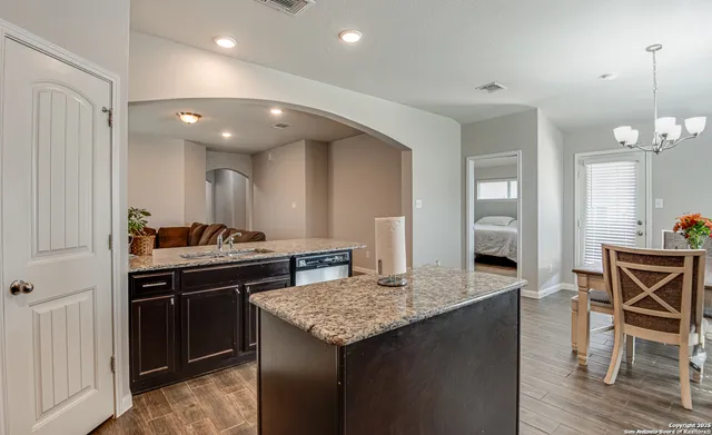 a kitchen with granite countertop cabinets and stove