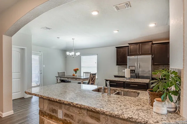 a kitchen with sink and refrigerator