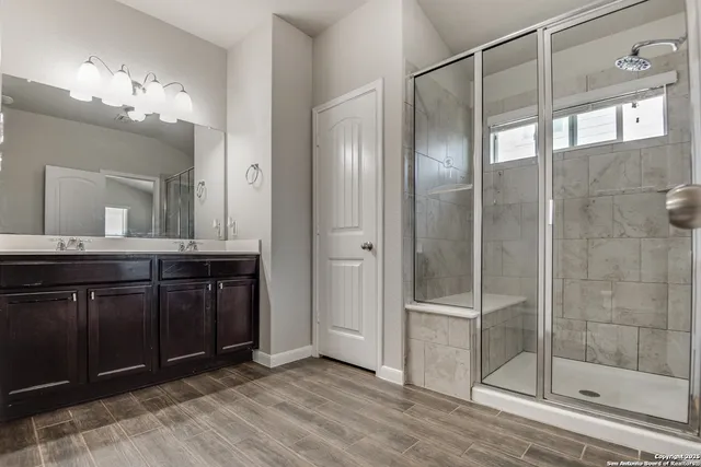 a bathroom with a double vanity sink and a mirror