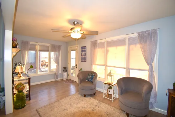 a bedroom with a bed a large window and furniture