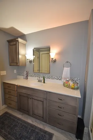 a bathroom with a sink a mirror and a shower