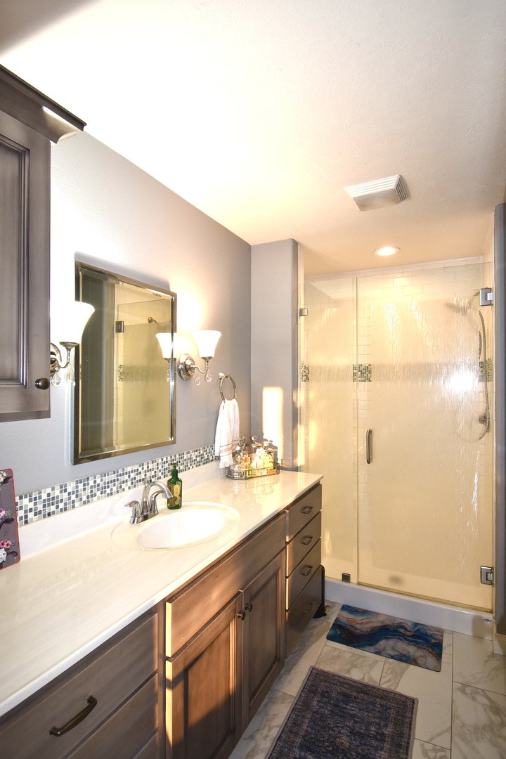 1915 Dunraven Road Bloomington, IL 61704 - Photo 16 of 26 a bathroom with a sink a mirror and a shower