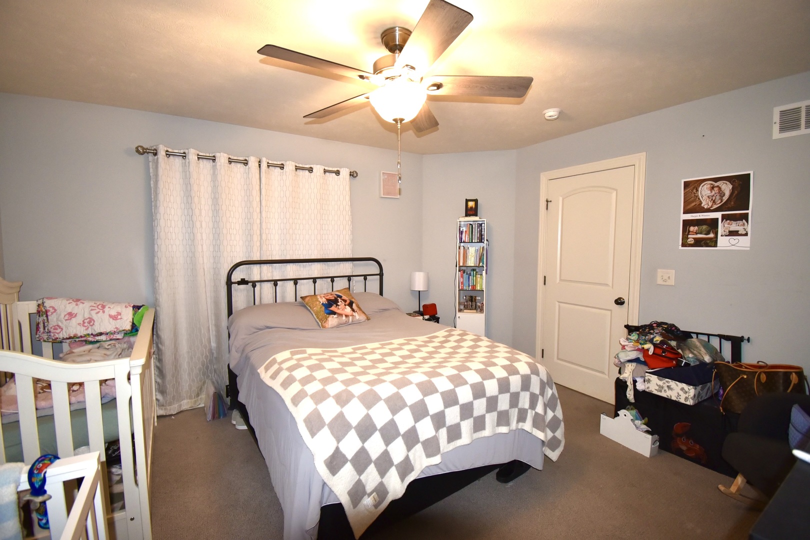 1915 Dunraven Road Bloomington, IL 61704 - Photo 17 of 26 a bedroom with a bed and a chandelier
