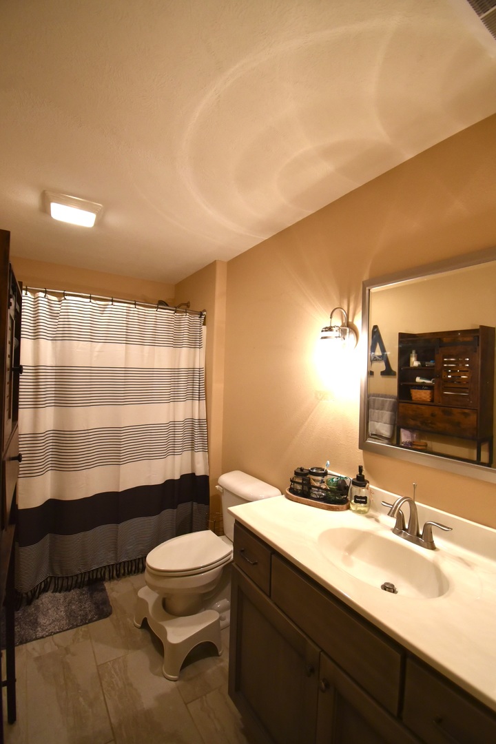 1915 Dunraven Road Bloomington, IL 61704 - Photo 23 of 26 a bathroom with a sink a toilet and shower