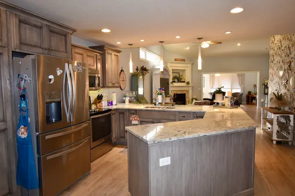 a living room with furniture a flat screen tv and a fireplace