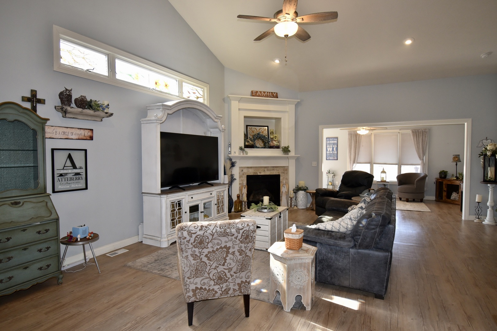 1915 Dunraven Road Bloomington, IL 61704 - Photo 8 of 26 a living room with furniture a flat screen tv and a fireplace