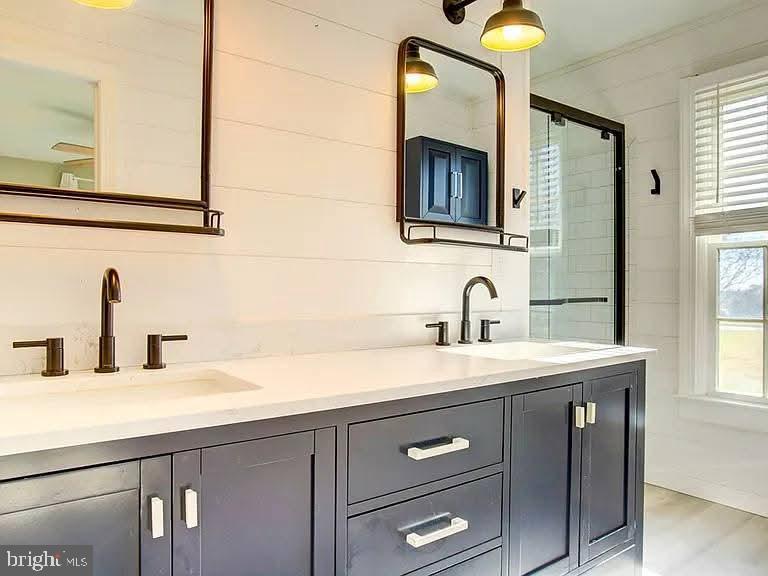 12148 Atlantic Road Temperanceville, VA 23442 - Photo 11 of 30 a bathroom with a sink and a mirror