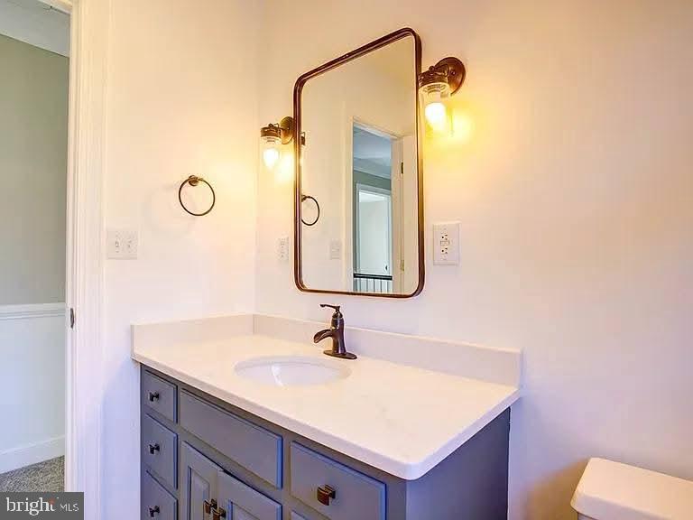 12148 Atlantic Road Temperanceville, VA 23442 - Photo 16 of 30 a bathroom with a sink vanity and a mirror