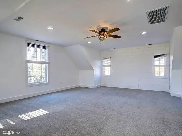 12148 Atlantic Road Temperanceville, VA 23442 - Photo 27 of 30 a view of a big room with windows and chandelier fan