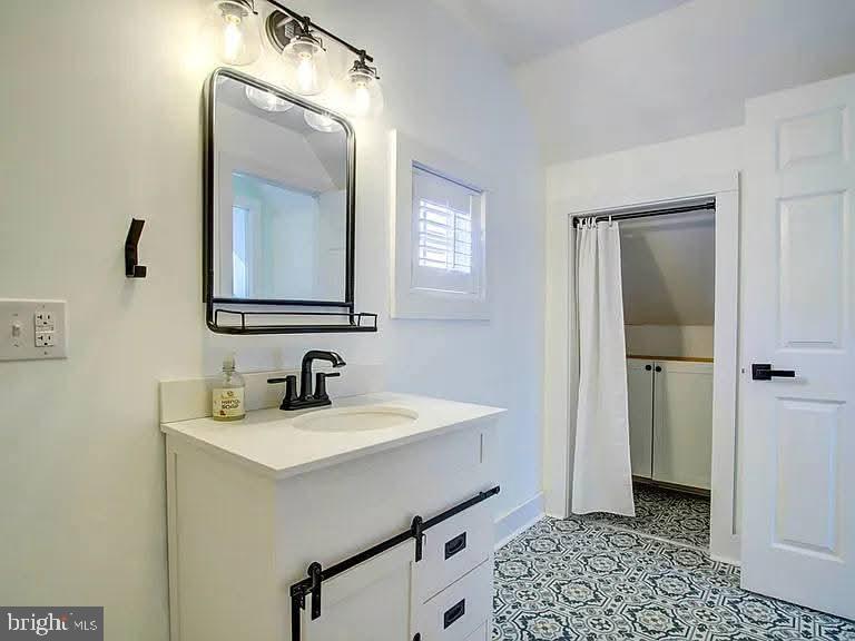 12148 Atlantic Road Temperanceville, VA 23442 - Photo 28 of 30 a bathroom with a sink a mirror and a toilet
