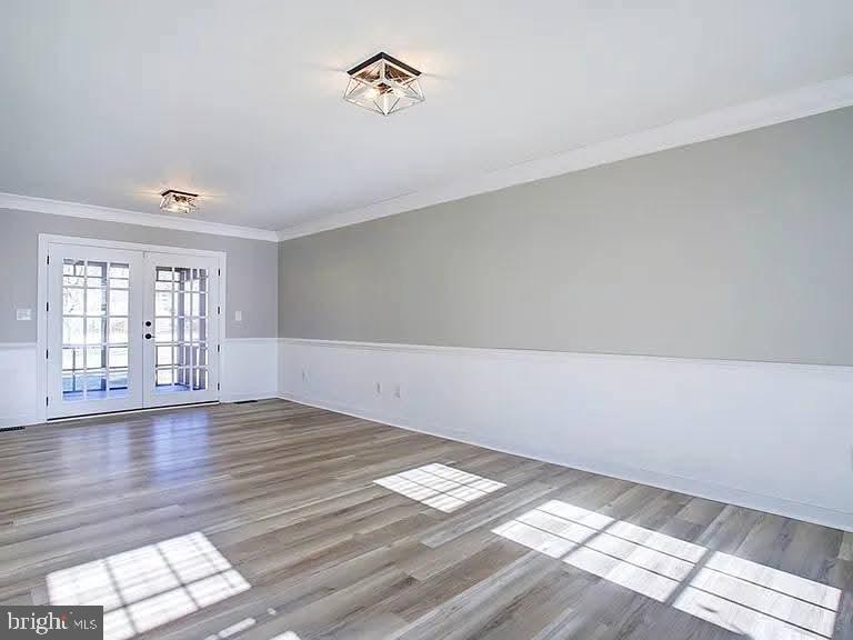 12148 Atlantic Road Temperanceville, VA 23442 - Photo 7 of 30 wooden floor in an empty room with a window