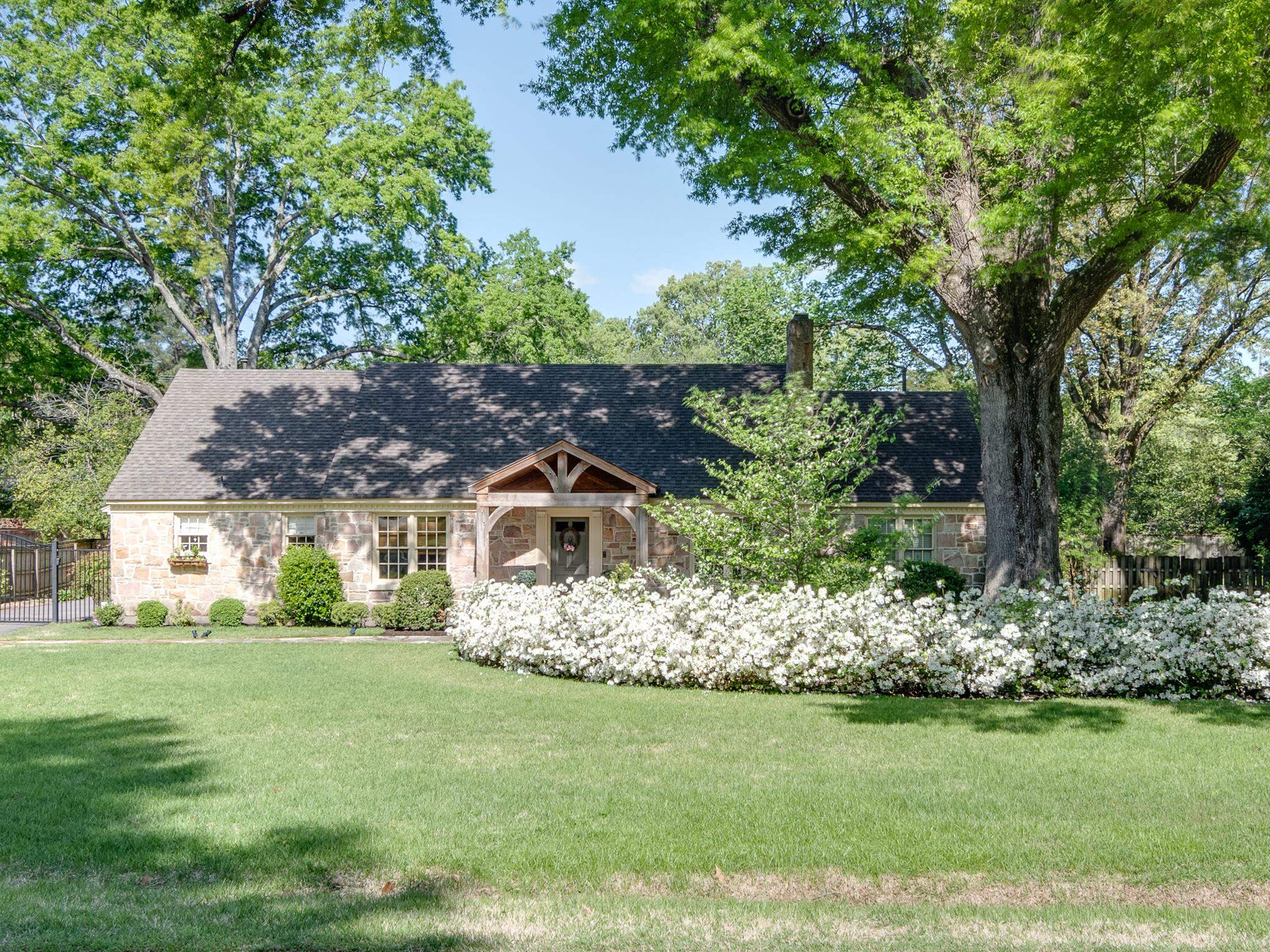a front view of a house with a garden
