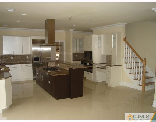 3 Fishel Road Edison, NJ 08820 - Photo 6 of 10 a kitchen with kitchen island stainless steel appliances a sink stove and refrigerator