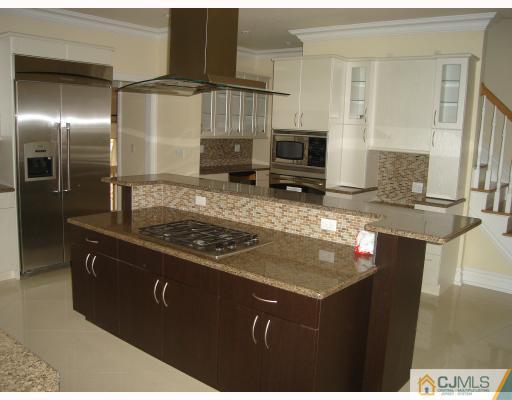 3 Fishel Road Edison, NJ 08820 - Photo 7 of 10 a kitchen with kitchen island granite countertop a sink stove and refrigerator