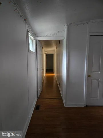 a view of gallery with wooden floor