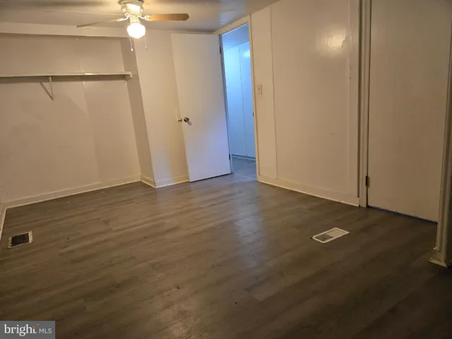 an empty room with wooden floor