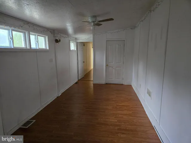 a view of hallway with wooden floor