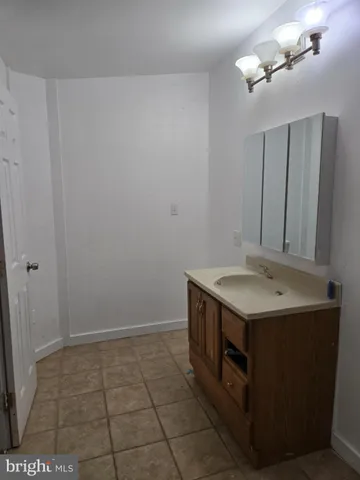 a utility room with a sink and cabinets