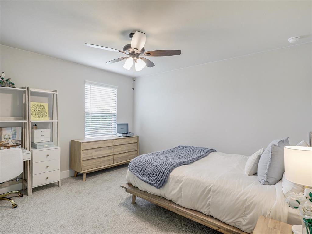 544 Majors Road Van Alstyne, TX 75495 - Photo 24 of 36 a bedroom with a bed and a chandelier