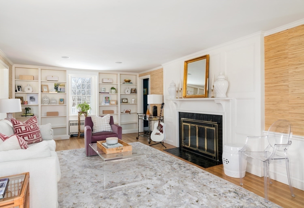 8 Rockwood Road Hingham, MA 02043 - Photo 11 of 27 a living room with furniture a fireplace and a table