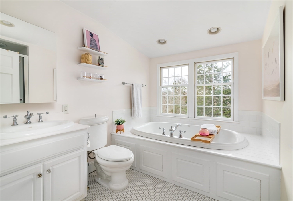 8 Rockwood Road Hingham, MA 02043 - Photo 21 of 27 a bathroom with a granite countertop sink and a large mirror