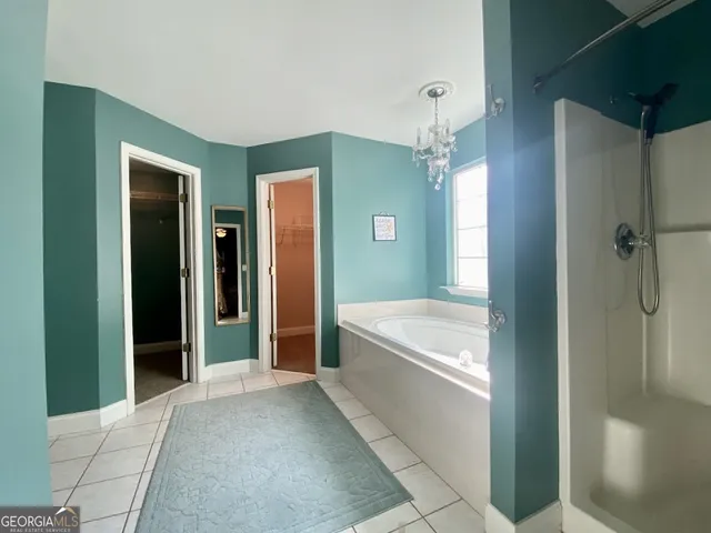 a bathroom with a tub shower and sink