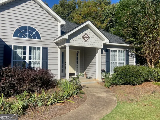a front view of a house with garden