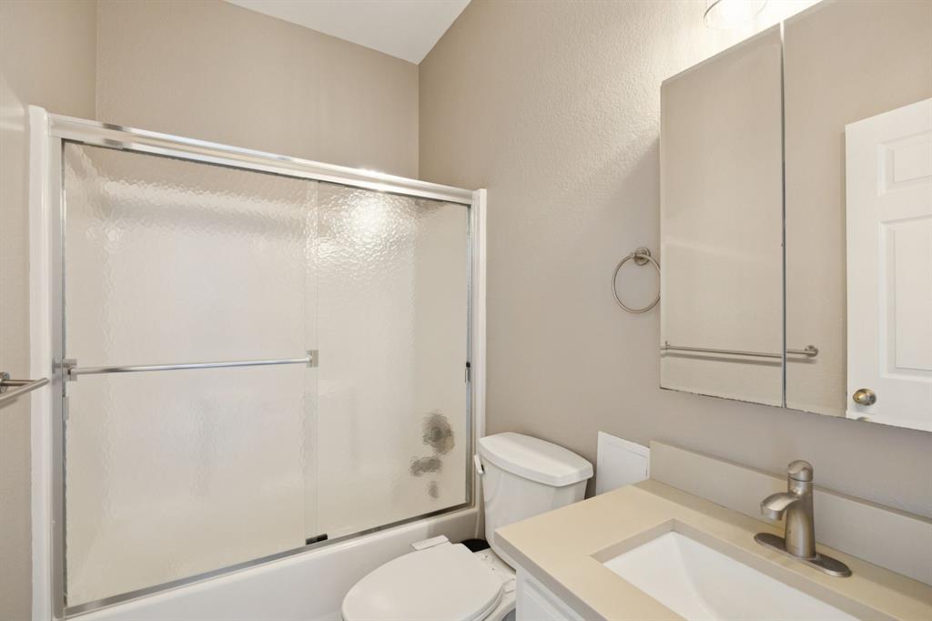 9530 County Road 581 Anna, TX 75409 - Photo 16 of 39 a bathroom with a sink toilet and shower