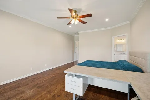 a living room with a bed furniture and a wooden floor