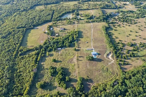 an aerial view of residential house with pool and garden