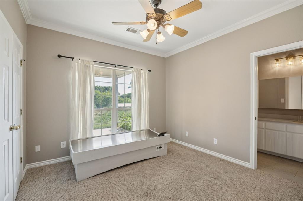 9530 County Road 581 Anna, TX 75409 - Photo 23 of 39 a spacious bedroom with a bed and a chandelier