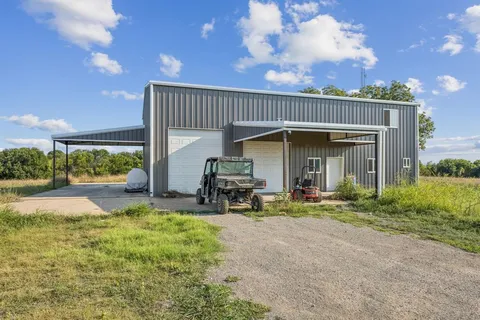 a swimming pool with outdoor seating and yard in back