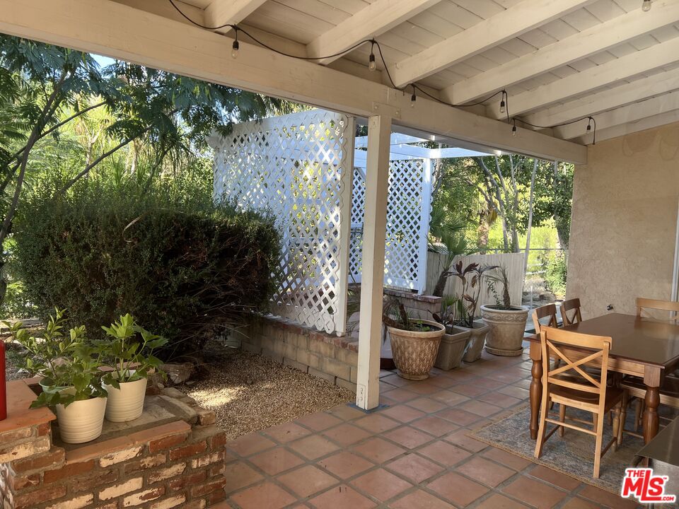 37200 Glen Oaks Road, Unit 3 Temecula, CA 92592 - Photo 18 of 42 a view of a porch with chairs and a potted plant
