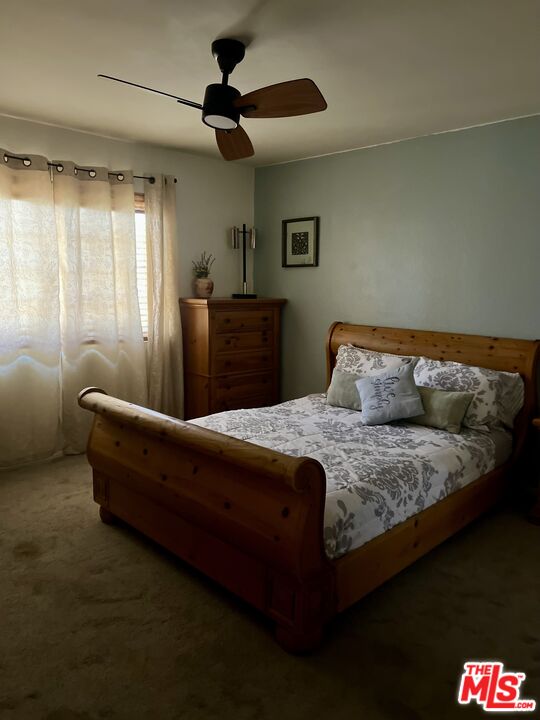 37200 Glen Oaks Road, Unit 3 Temecula, CA 92592 - Photo 24 of 42 a bedroom with a bed and a chandelier