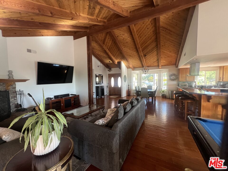 37200 Glen Oaks Road, Unit 3 Temecula, CA 92592 - Photo 27 of 42 a living room with furniture a flat screen tv and kitchen view