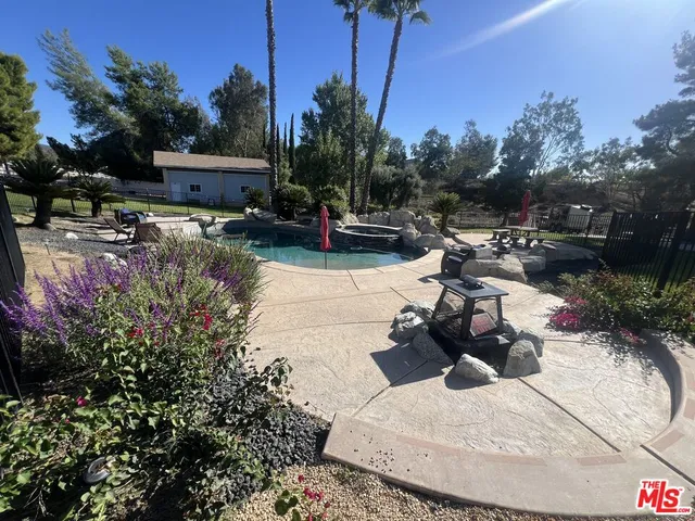 a view of a balcony with a floor to ceiling window and palm tree
