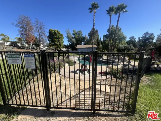 a swimming pool covered with tall trees