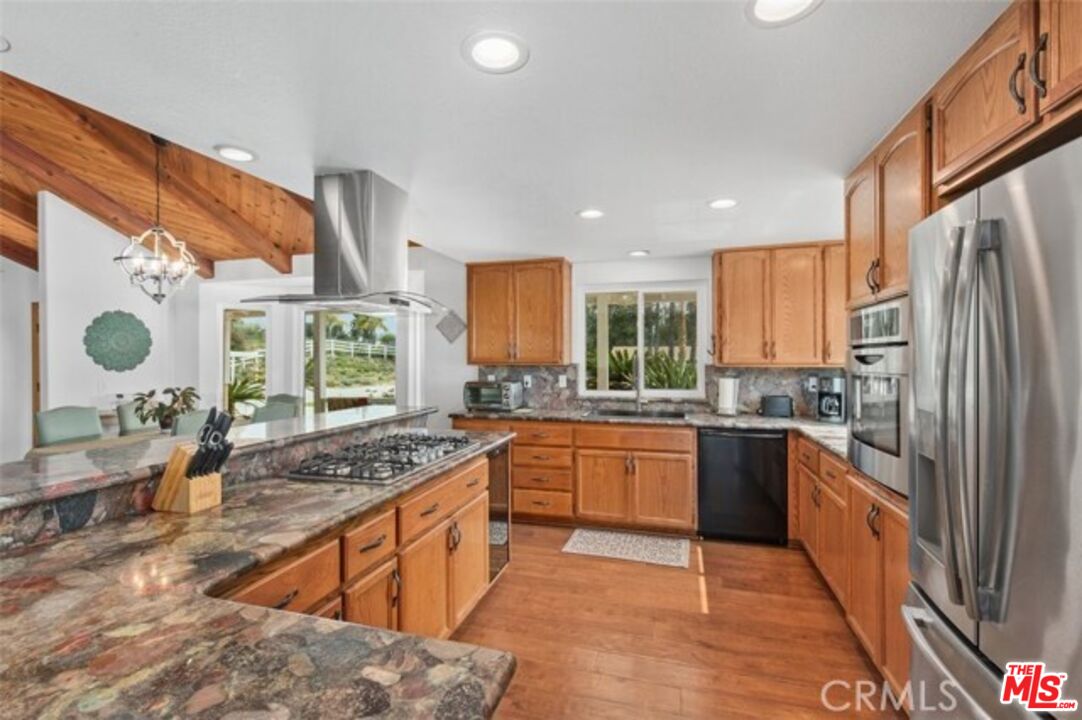 37200 Glen Oaks Road, Unit 3 Temecula, CA 92592 - Photo 5 of 42 a kitchen with stainless steel appliances granite countertop sink stove refrigerator and cabinets
