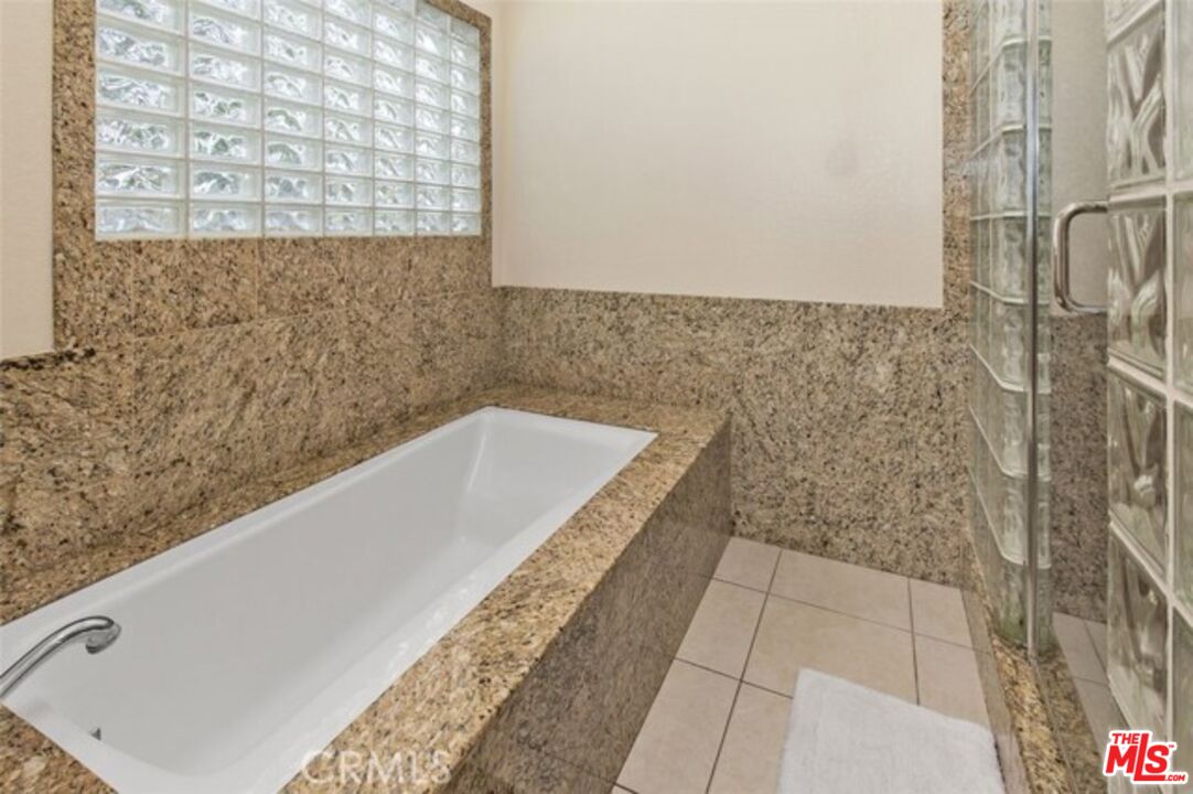 37200 Glen Oaks Road, Unit 3 Temecula, CA 92592 - Photo 9 of 42 a bath tub sitting in a bathroom next to a window