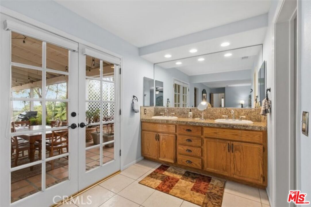37200 Glen Oaks Road, Unit 3 Temecula, CA 92592 - Photo 10 of 42 a bathroom with a granite countertop sink a mirror and a shower