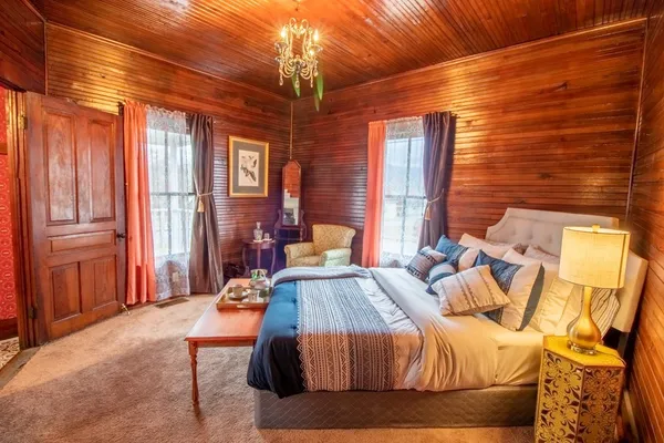 a bed sitting in a bedroom next to a window